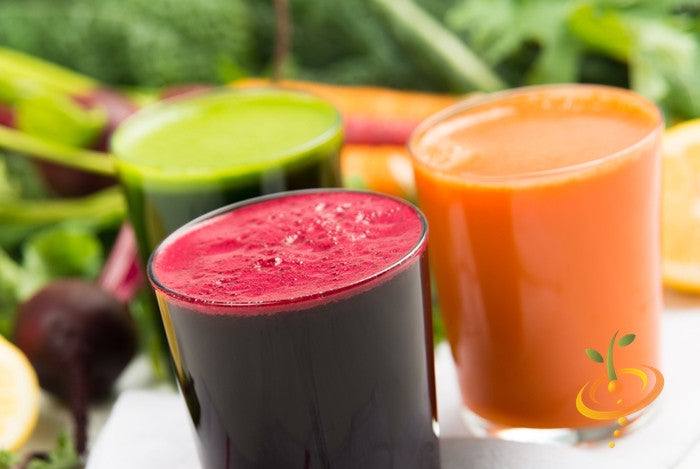 Three glasses of fresh vegetable juice including vibrant red Boltardy beet juice in the foreground