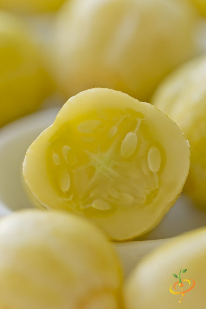Close-up of lemon cucumber seeds inside a bright yellow cucumber slice