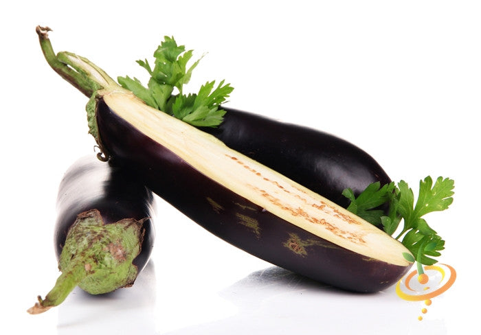 Glossy dark purple eggplants with one sliced open, featuring green leaves against a white background.