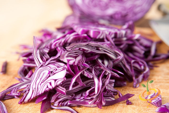 Red Acre seeds variety red cabbage sliced on wooden cutting board